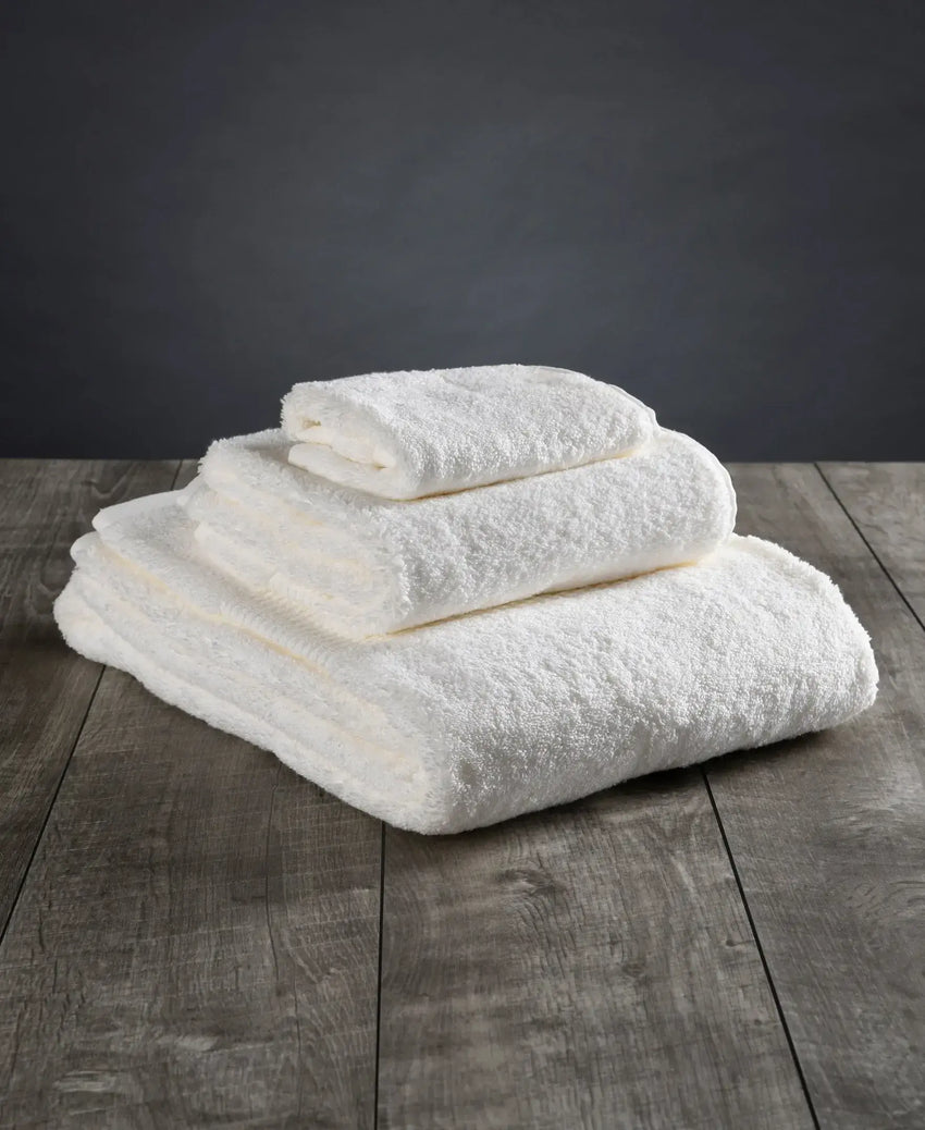 Folded white organic cotton bath towels