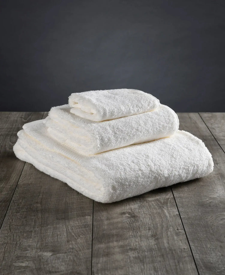 Folded white organic cotton bath towels