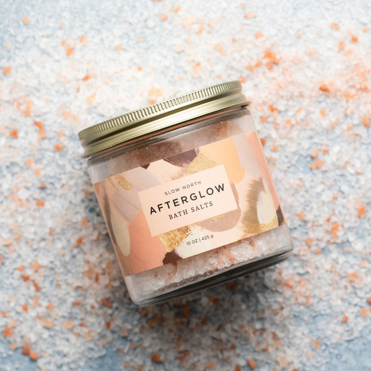 Afterglow bath salts jar on scattered pink bath salts