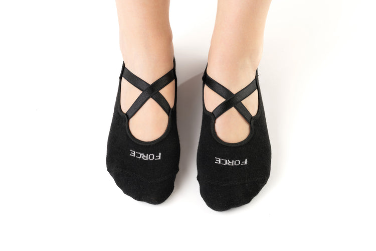 Black Pilates grip socks with ballet-style cross straps