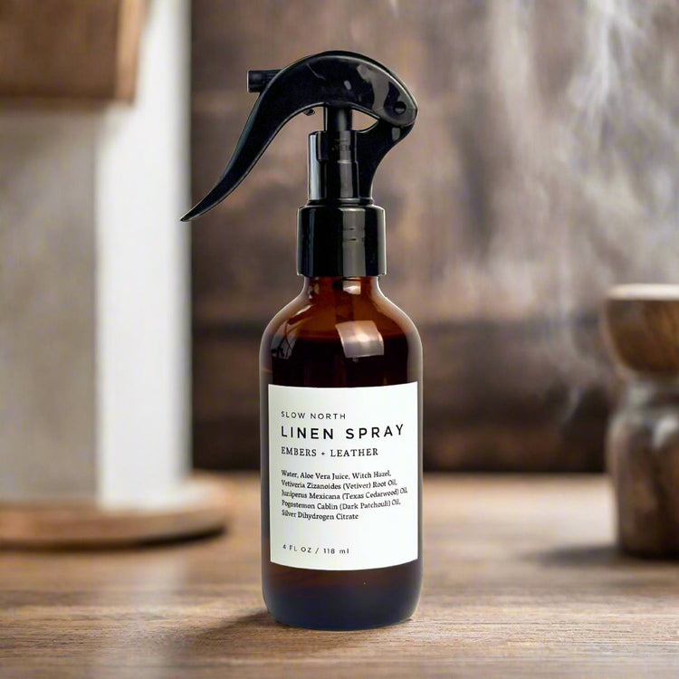 Embers and Leather linen spray in an amber bottle