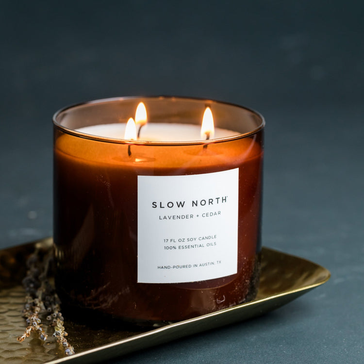 Lavender and Cedar three-wick candle in an amber glass jar