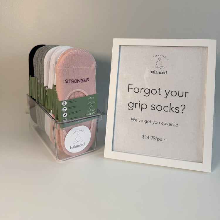 Small studio set of ballet grip socks displayed beside a studio retail sign