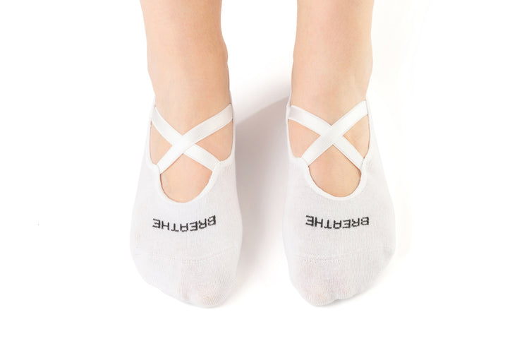 White cotton Pilates grip socks with cross straps